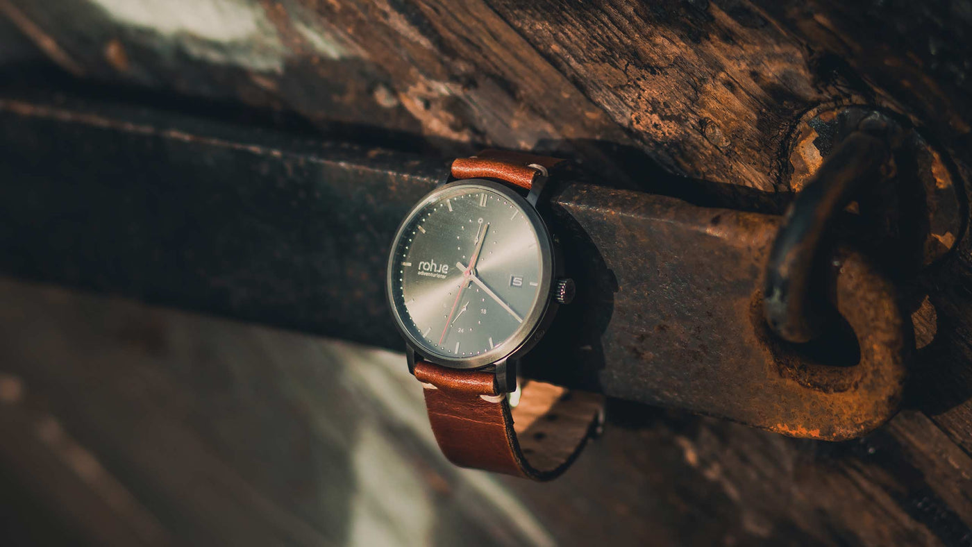 adventurister Dark watch on a dark wooden background