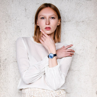 women white shirt pose with artister into the blue on her wrist