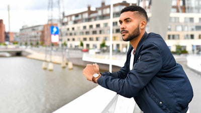 men standing on the bridge and wearing adventurister gold watch small size